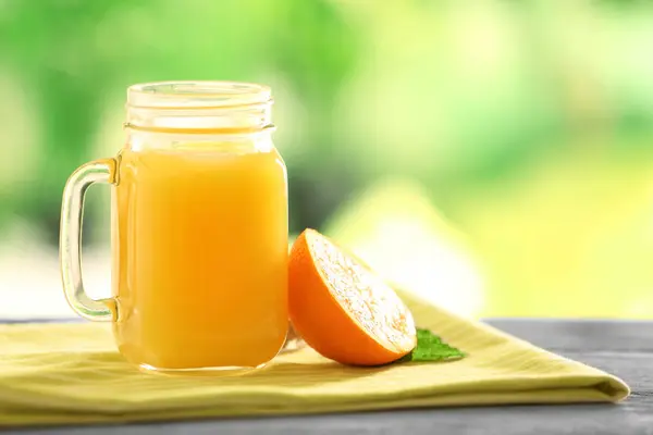 Mason jar with delicious orange juice — Stock Photo, Image