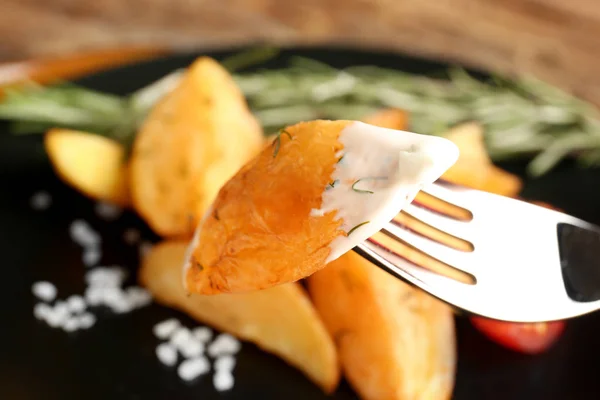 Fork with delicious baked potato wedge — Stock Photo, Image