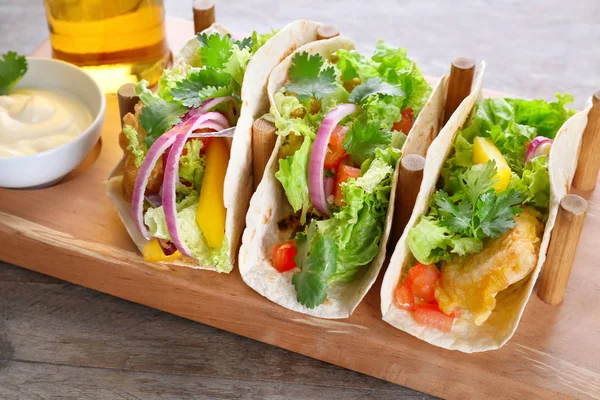 Wooden holder with yummy fish tacos — Stock Photo, Image