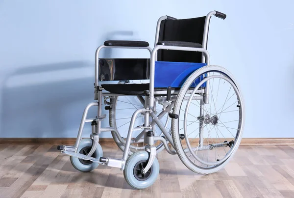 Інвалідне крісло проти кольорової стіни — стокове фото
