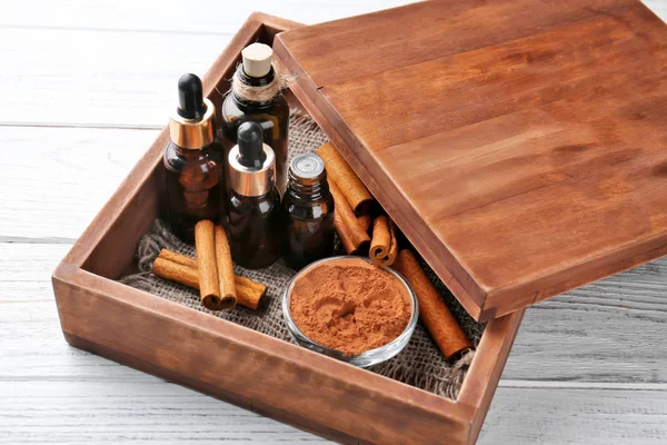 Essential cinnamon oil in glass bottles — Stock Photo, Image