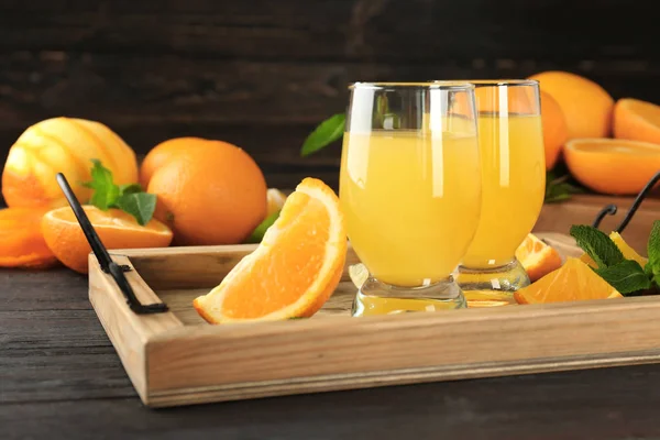 Glasses with delicious orange juice — Stock Photo, Image