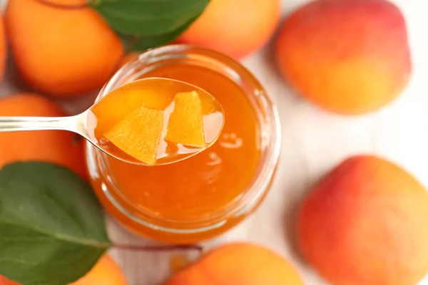 Apricot homemade jam in jar with spoon — Stock Photo, Image