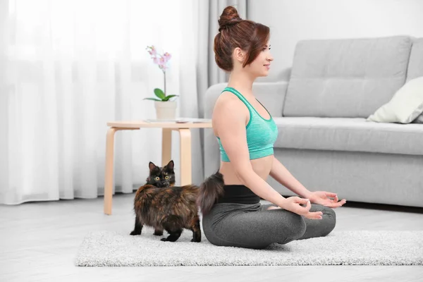 练瑜伽的猫的年轻女子 — 图库照片