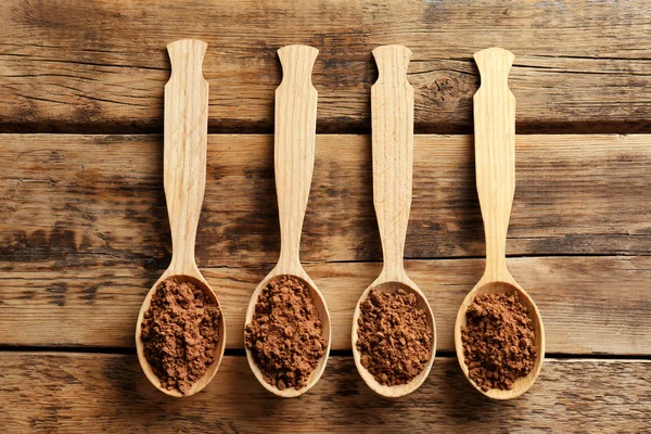 Spoons with cocoa powder — Stock Photo, Image