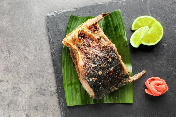 Slate plate with delicious fried fish