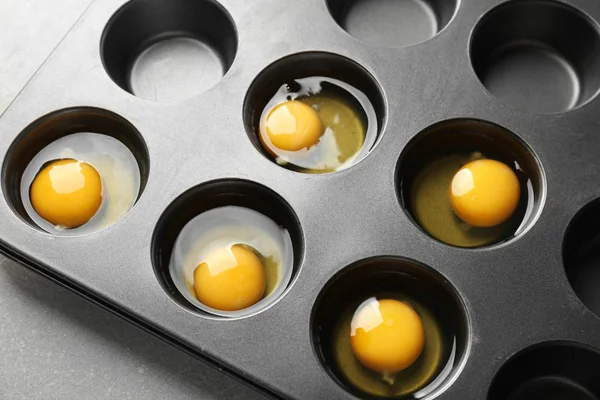 Muffin tin with raw eggs — Stock Photo, Image