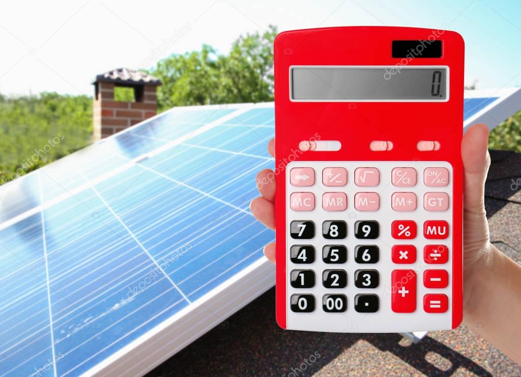 Woman holding calculator and solar panels 