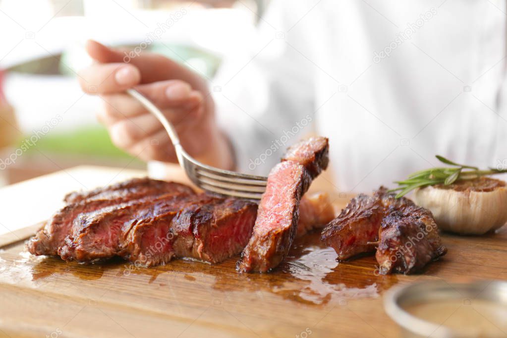 woman eating grilled steak 