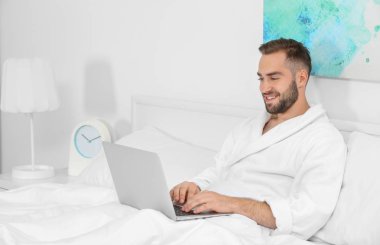 Genç adam dizüstü bilgisayar kullanıyor