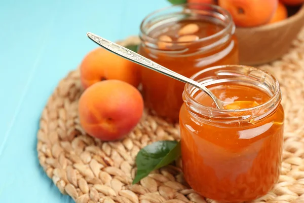 Apricot jam in jars with spoon — Stock Photo, Image