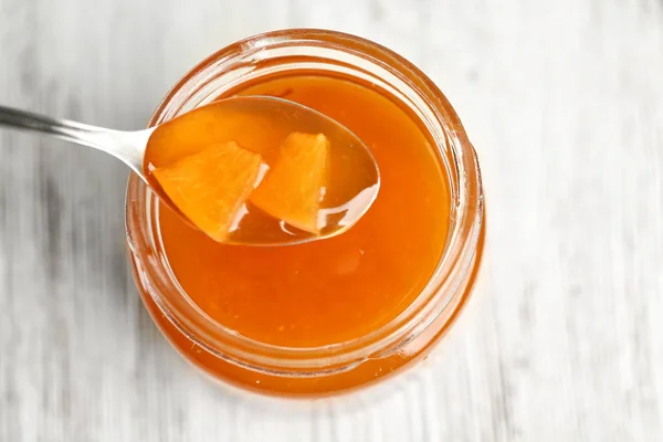 Apricot homemade jam in jar with spoon