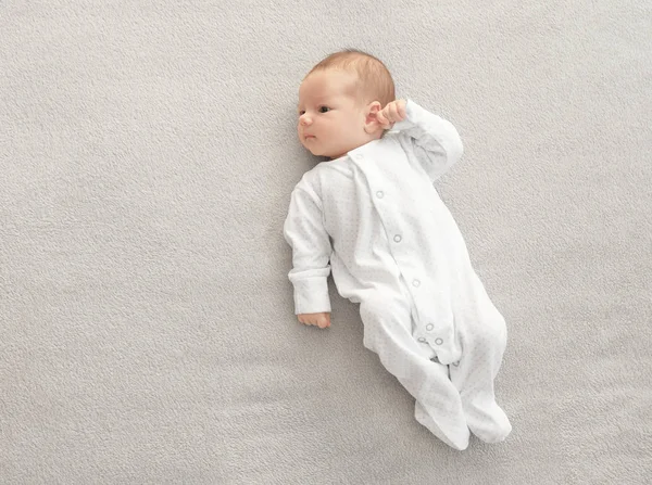 Cute little baby lying on soft plaid at home — Stock Photo, Image