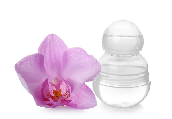 Female deodorant and orchid flower on white background — Stock Photo, Image