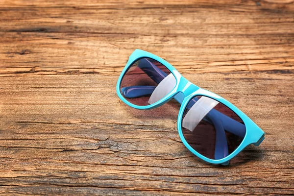 Beautiful sunglasses on wood — Stock Photo, Image