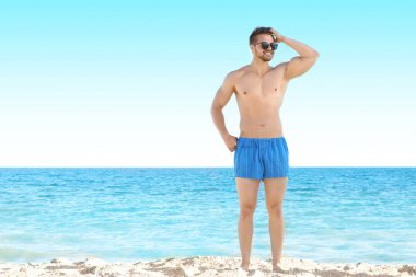 Yakışıklı genç adam sahilde