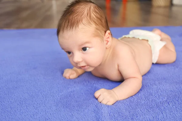 Cute little baby lying on soft plaid — Stock Photo, Image