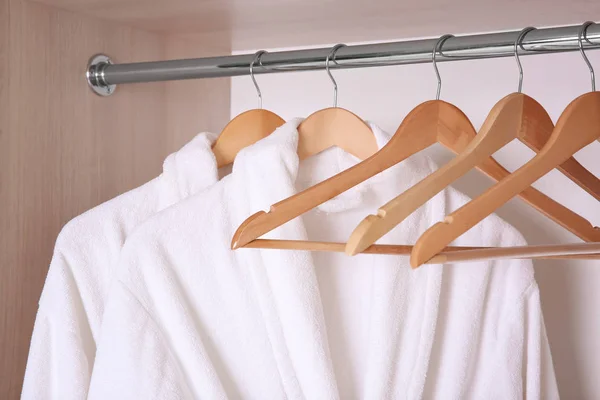 Bathrobes hanging in wardrobe — Stock Photo, Image