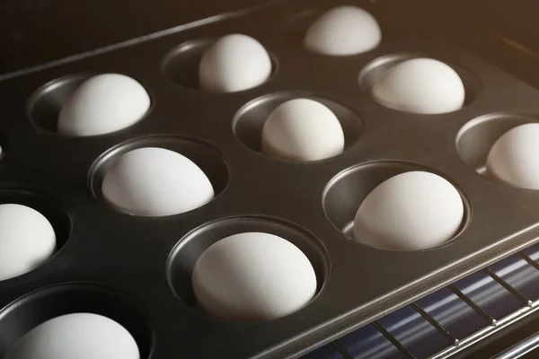 Muffin tin with hard boiled eggs — Stock Photo, Image