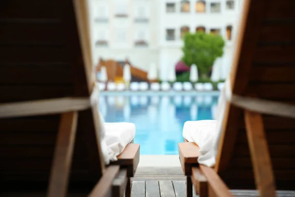 Camas de sol vazias perto da piscina — Fotografia de Stock