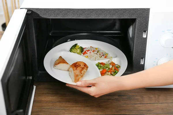 Plaka mikrodalga koyarak kadın