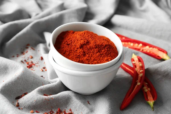 Chili powder and cut pepper pods — Stock Photo, Image