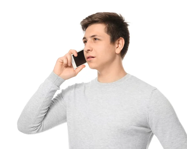 Schattige tiener jongen met mobiele telefoon op witte achtergrond — Stockfoto