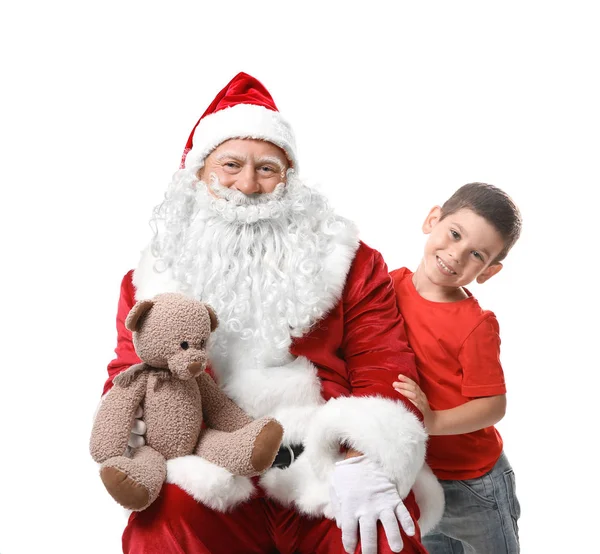 Menino bonito e autêntico Papai Noel com ursinho de pelúcia contra fundo branco — Fotografia de Stock