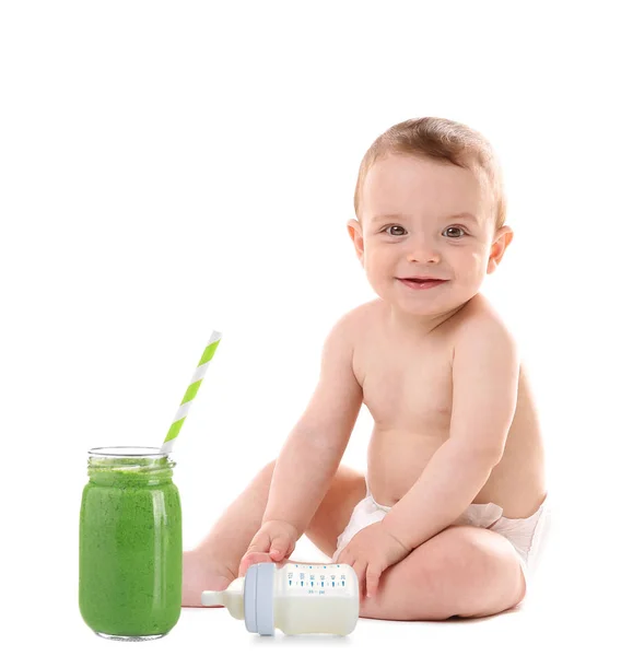 Cute little boy with feeding bottle and glass jar of smoothie on white background. Concept of healthy nutrition for babies and toddlers — Stock Photo, Image