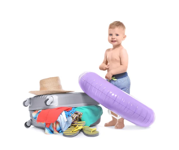 Happy baby with inflatable ring and travel suitcase on white background. Holiday concept — Stock Photo, Image