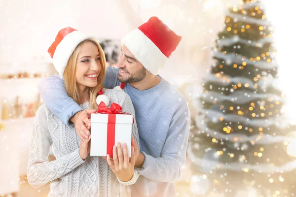 Happy couple in Santa hats — Stock Photo, Image