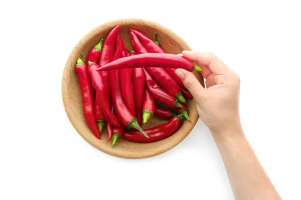 Woman's hand taking red chili pepper out of bowl — Stock Photo, Image