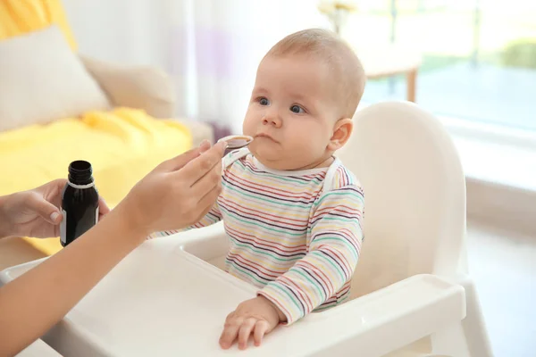 Mother giving medicine for baby indoors — Stock Photo, Image