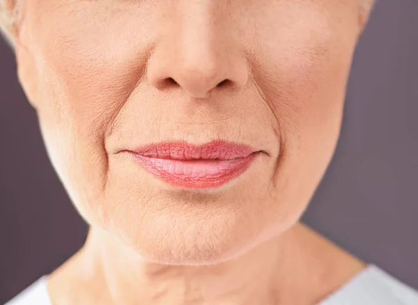 Vista de close-up da bela mulher idosa no fundo cinza — Fotografia de Stock