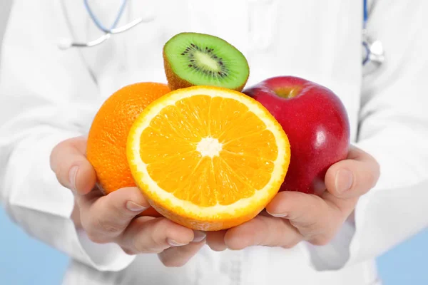 Young female nutritionist with fresh fruits — Stock Photo, Image