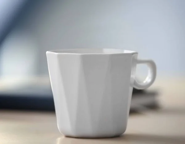 White cup on office table, closeup — Stock Photo, Image