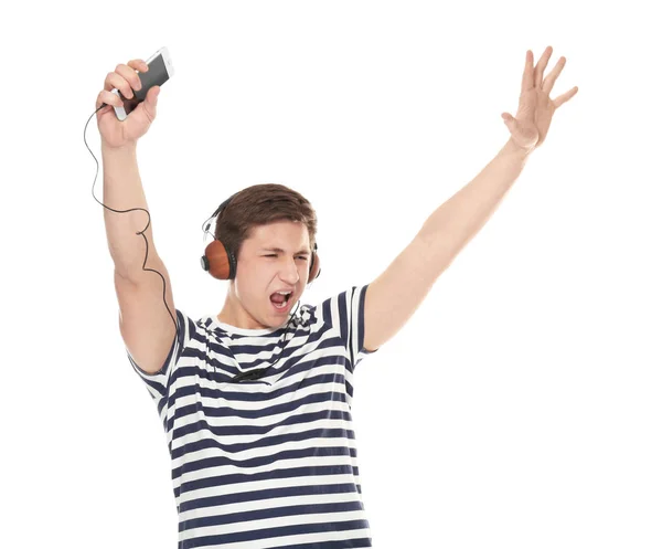 Bonito adolescente com telefone celular e fones de ouvido ouvindo música no fundo branco — Fotografia de Stock