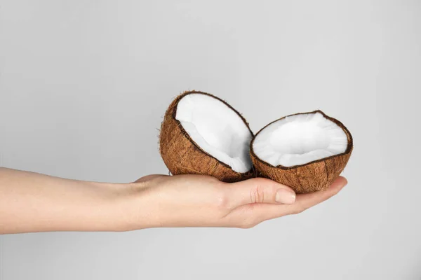 Hand with cracked coconut — Stock Photo, Image