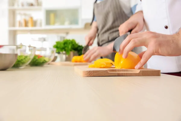 Chef giving cooking classes in kitchen