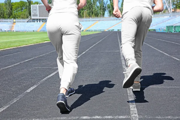 Fiatal pár, futás-on stadion — Stock Fotó