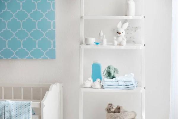 Beautiful light room with toys and baby accessories on shelves — Stock Photo, Image