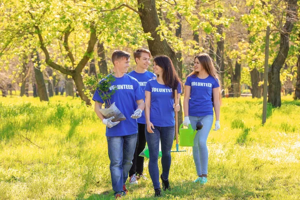 Group of young volunteers in park on sunny day — Stock Photo, Image