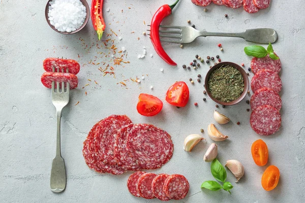 Composition with sliced sausage and chili pepper on table — Stock Photo, Image