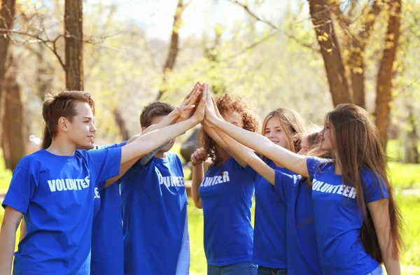Group of young volunteers in park on sunny day — Stock Photo, Image