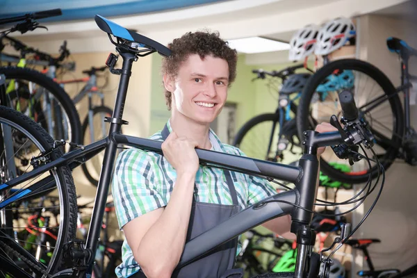 Bisiklet dükkanı tutan genç adam — Stok fotoğraf