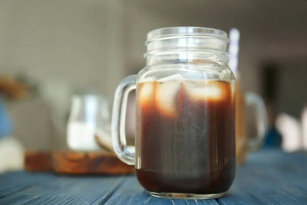 Einmachglas mit kalt gebrühtem Kaffee und Eis auf Holztisch — Stockfoto