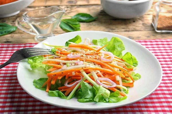Plate with delicious carrot salad on table — Stock Photo, Image