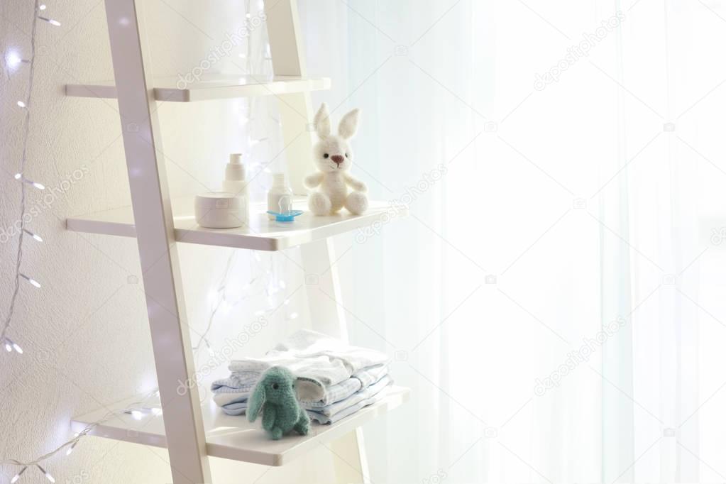 Beautiful light room with toys and baby accessories on shelves