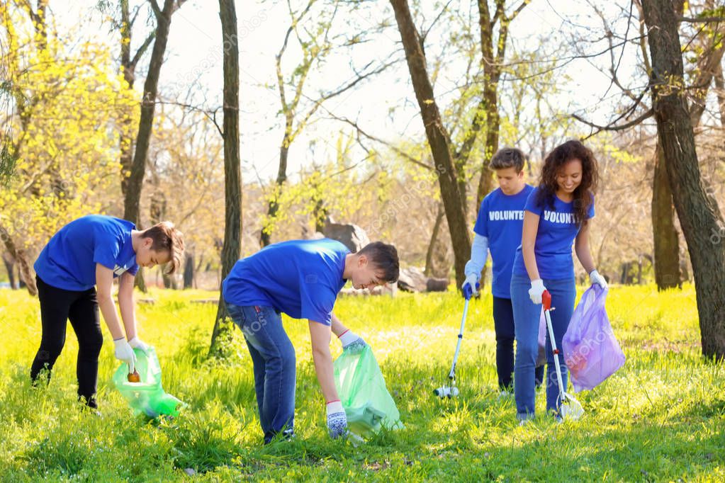 Group of young volunteers in park on sunny day