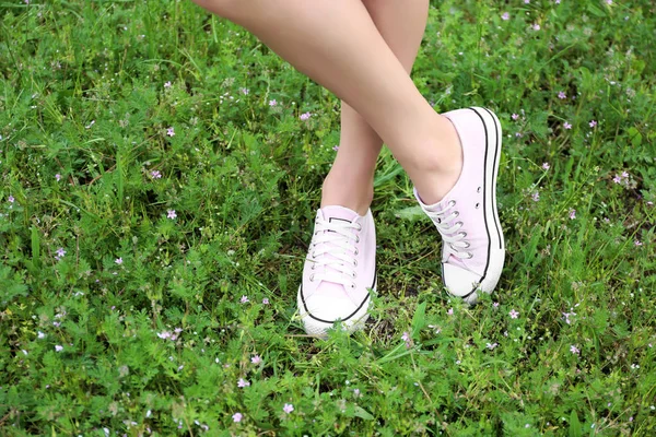 Patas femeninas en zapatillas rosas —  Fotos de Stock
